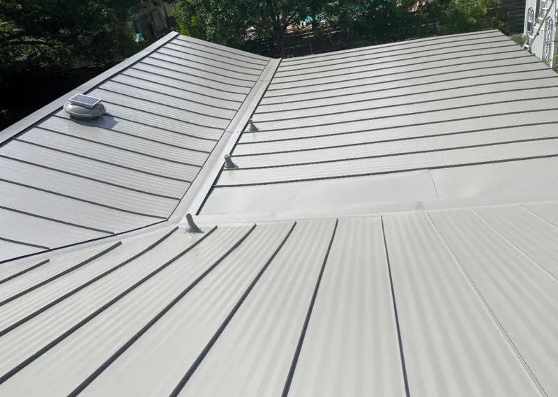 Solar attic fan installed on a metal roof for Roof Ventilation in Crawfordsville